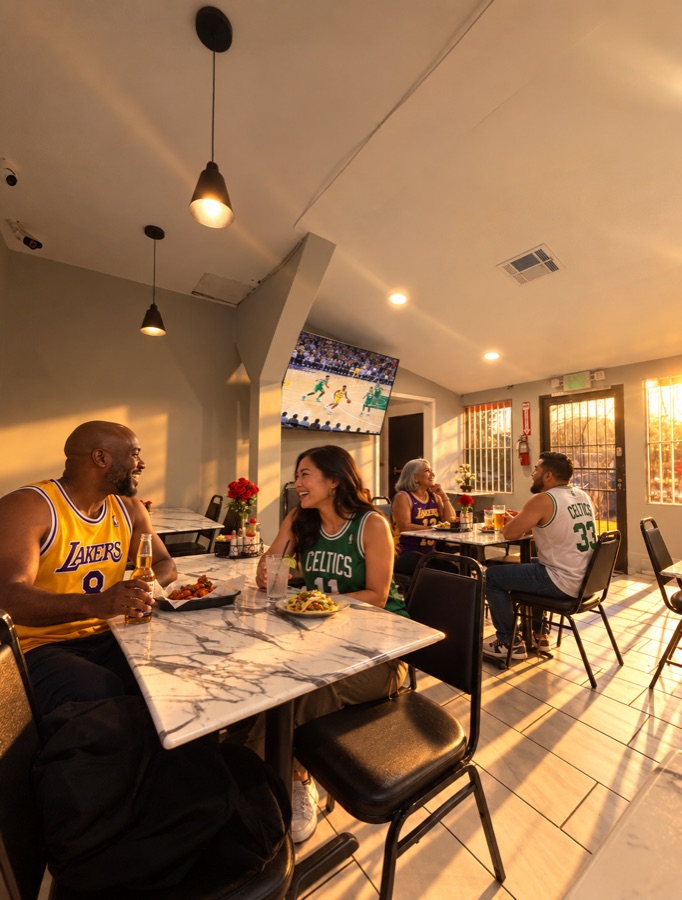 Guests in Lakers and Celtics jerseys watching basketball at golden hour; a staged promotional scene
