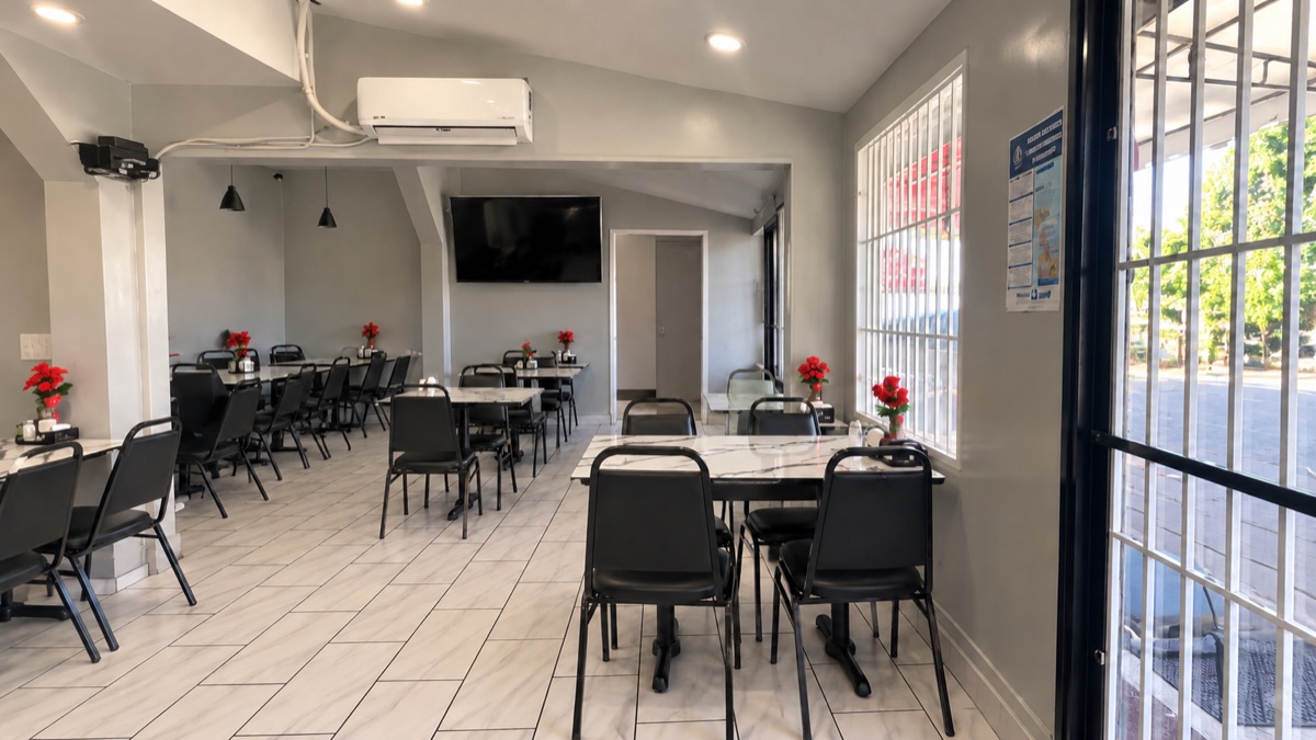 Dining room looking toward the barred front windows, tables with red flowers