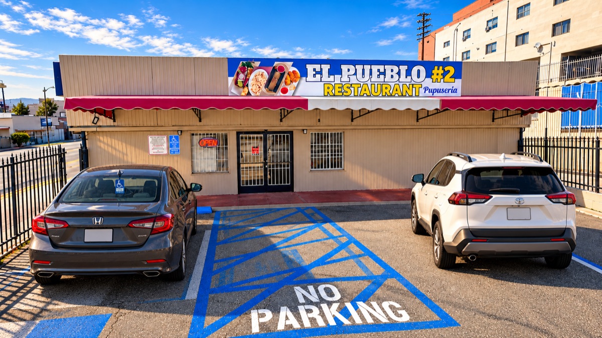 The storefront on Beverly Boulevard in golden light with two cars parked in front; a staged promotional image.